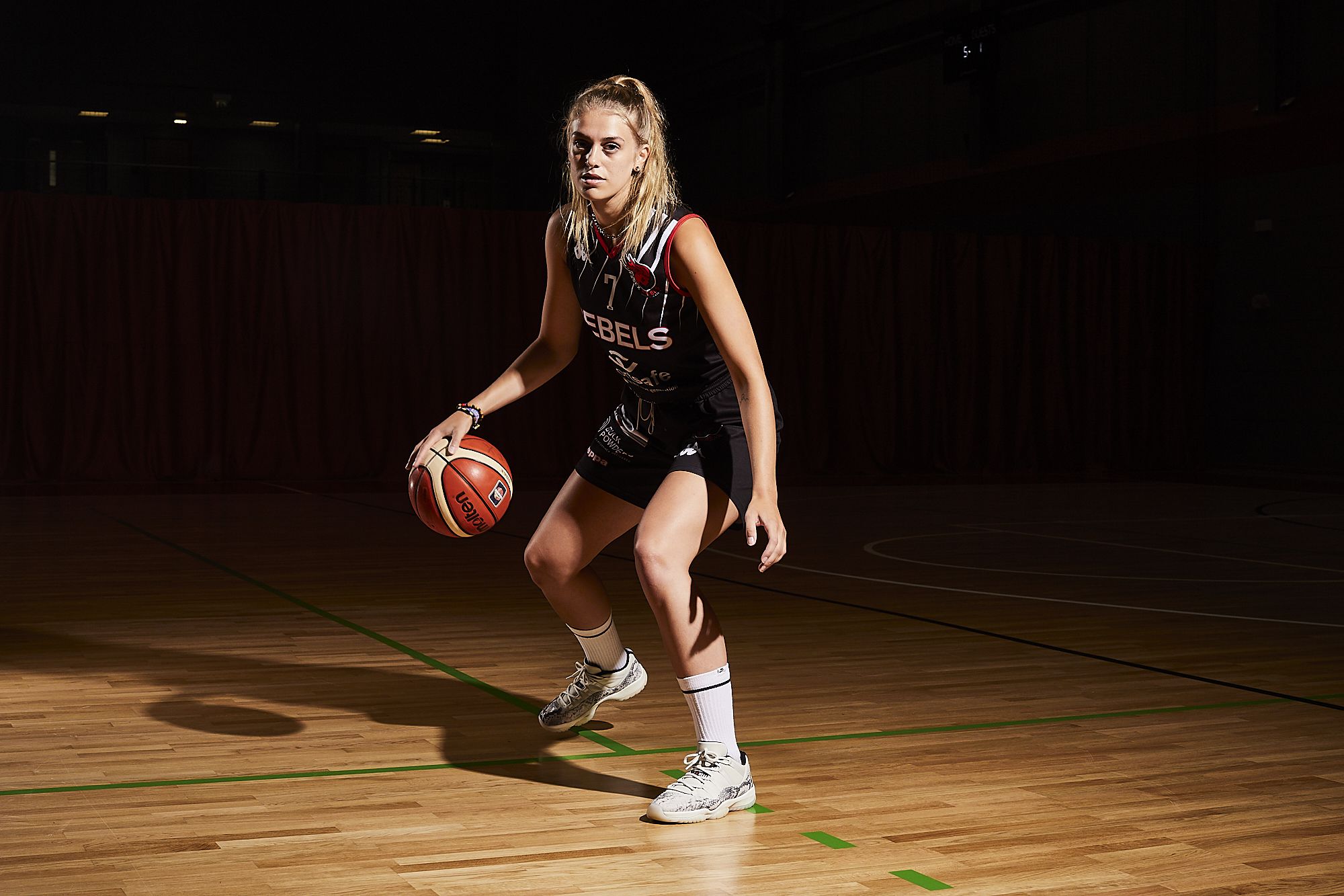 Rebels basketball player bouncing a basketball
