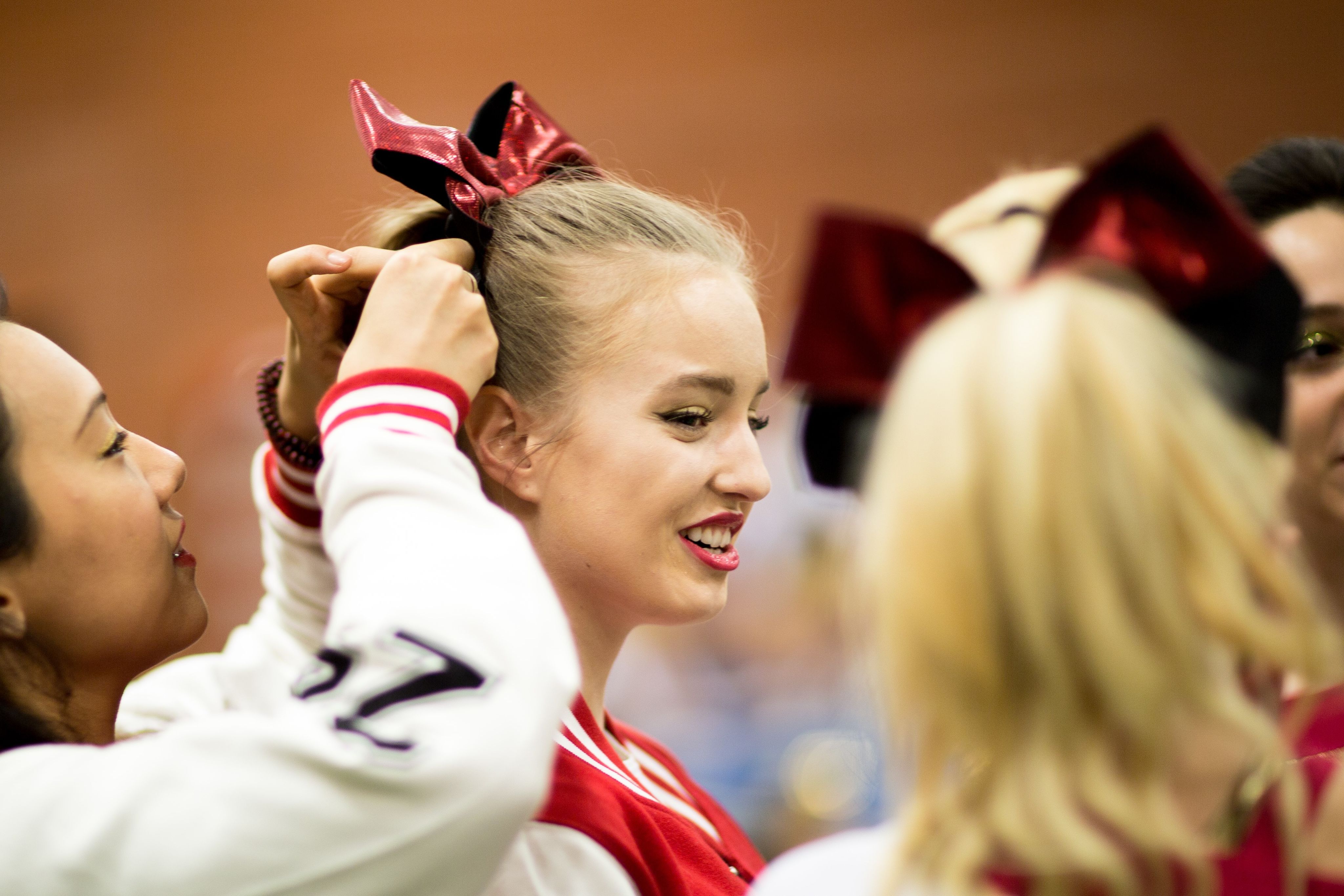 Cheerleaders sorting hair bow