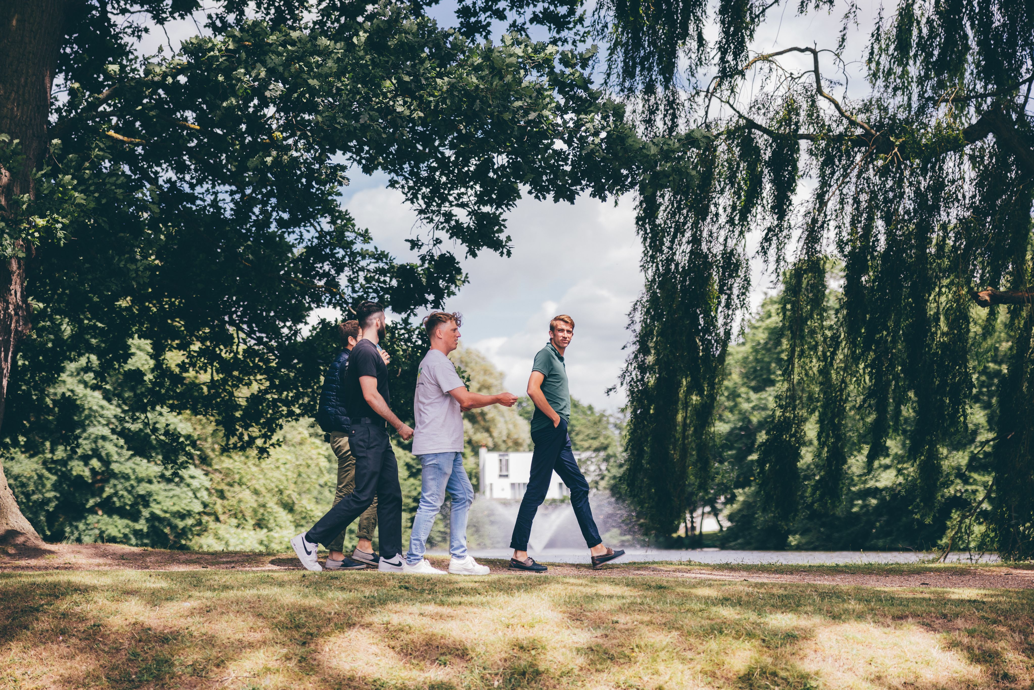 Students walking past the lake