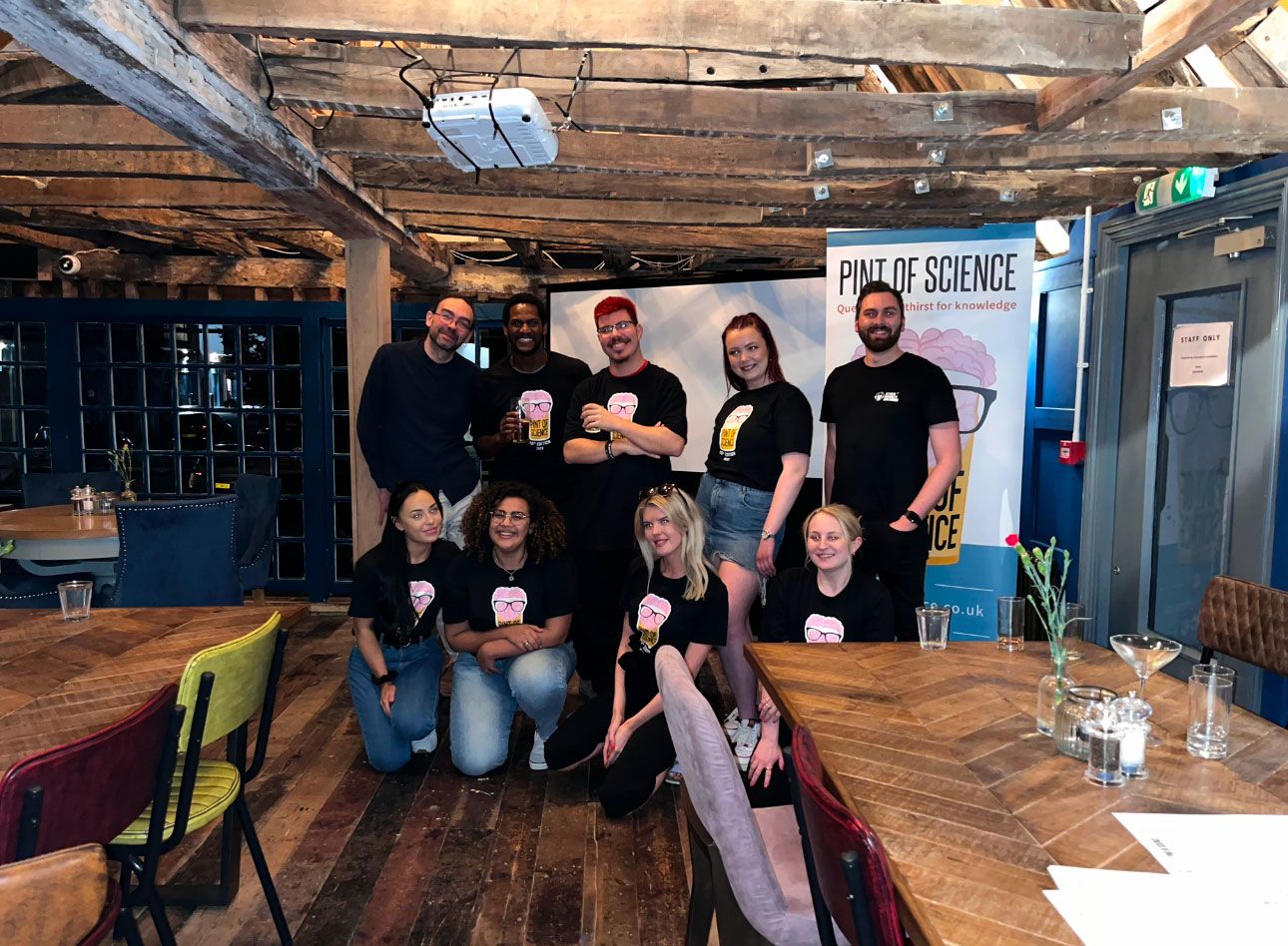 Group of students running pint of science at an event