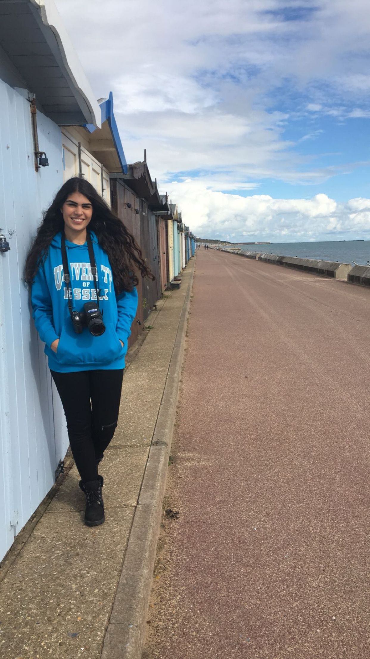 Ela stook in front of a row of beach huts on the Essex coast
