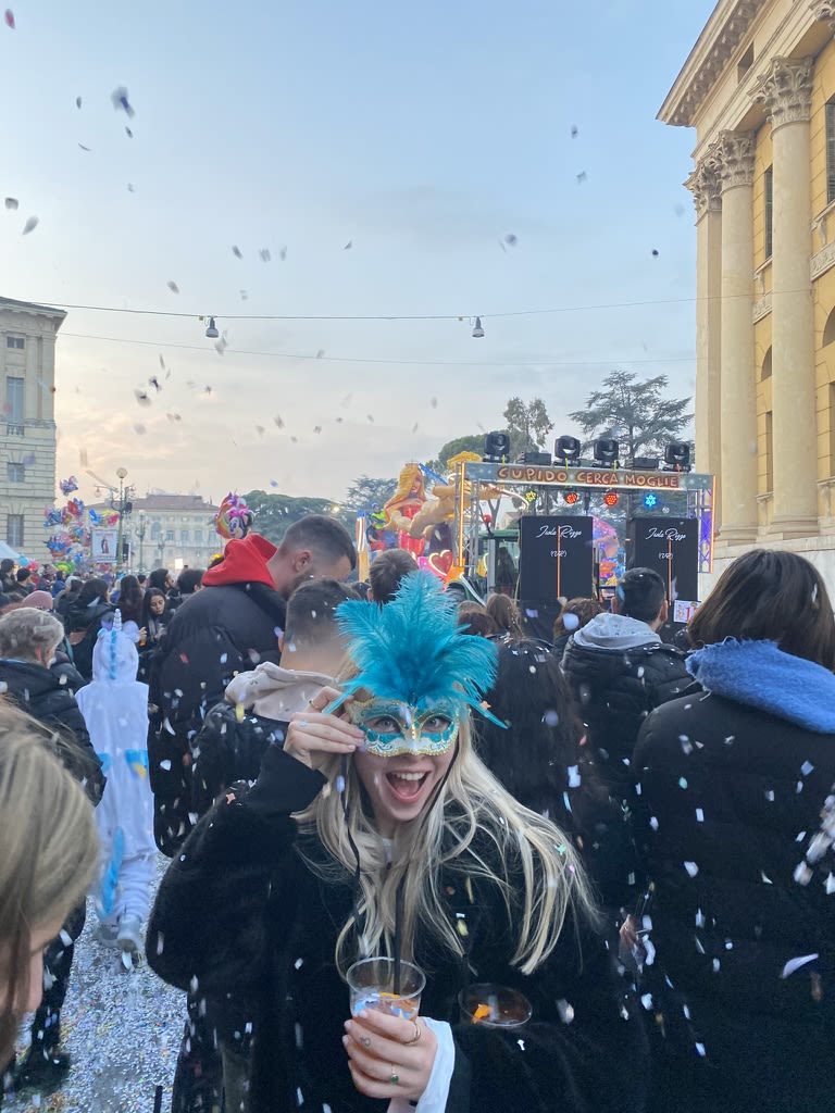 Lily-May wearing a bright blue venetian style mask