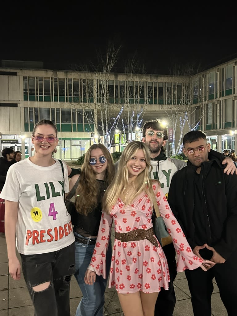 Group of students, one is wearing a "Lily 4 president" t-shirt
