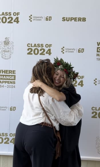 Lily-May hugging her mum dressed in her graduation robes