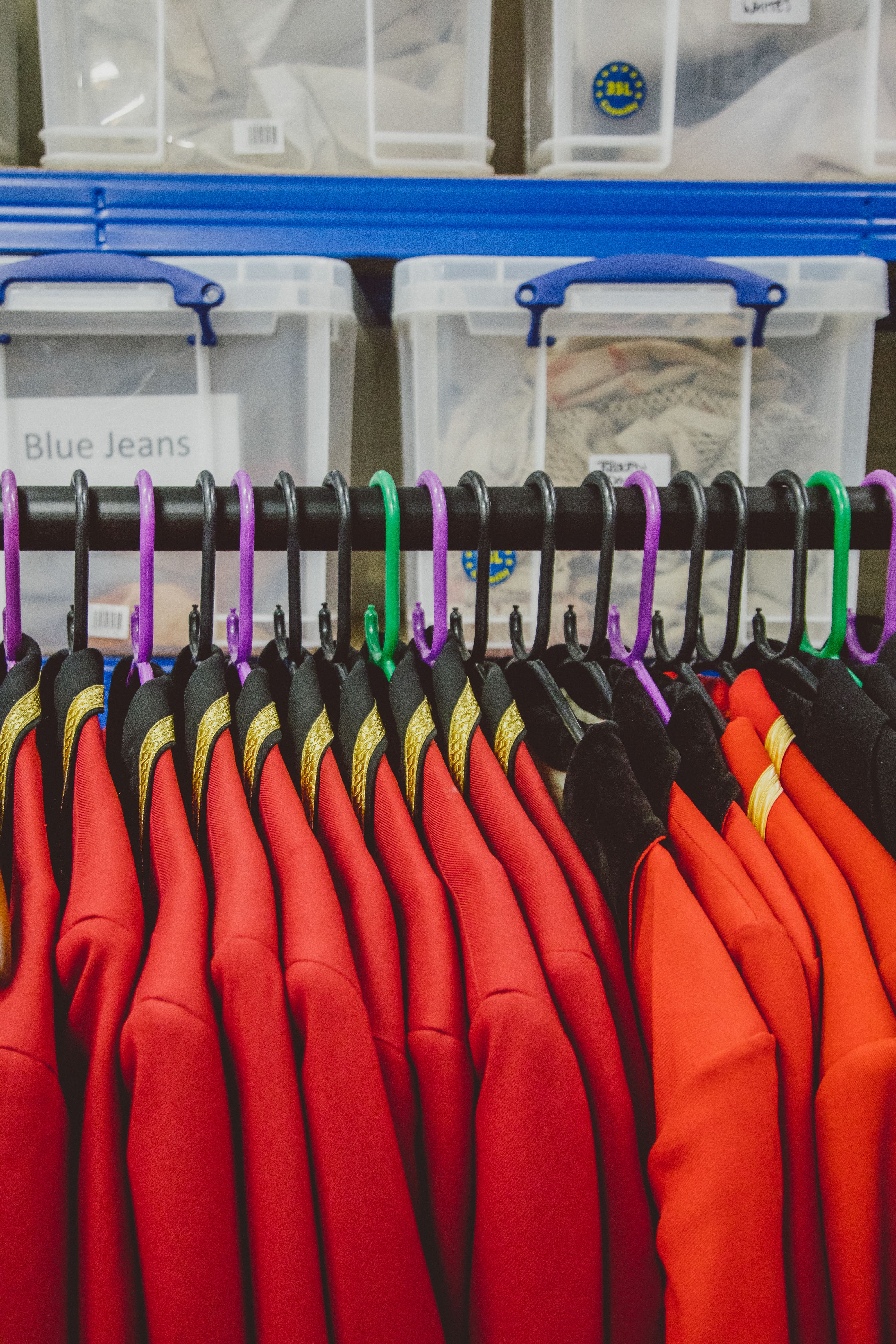 Rail full of smart red regency uniforms