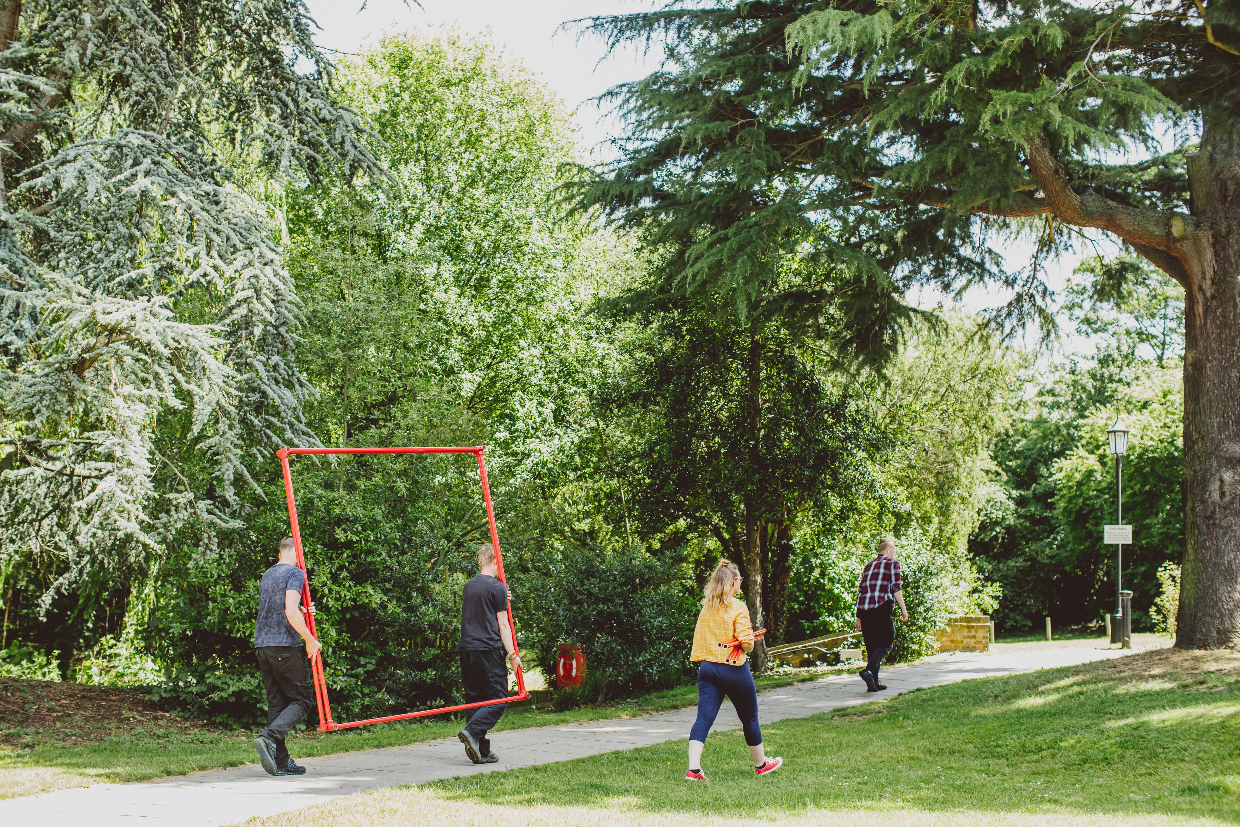 Student carrying props across the grounds