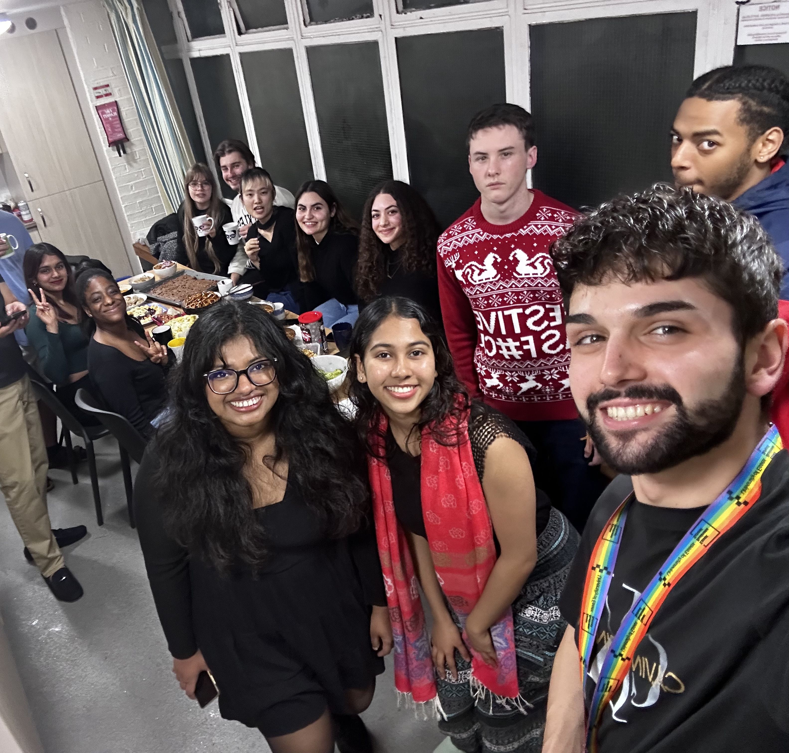 Michael with his flatmates in the kitchen in Towers accommodation. Everyone is smiling and looks happy.