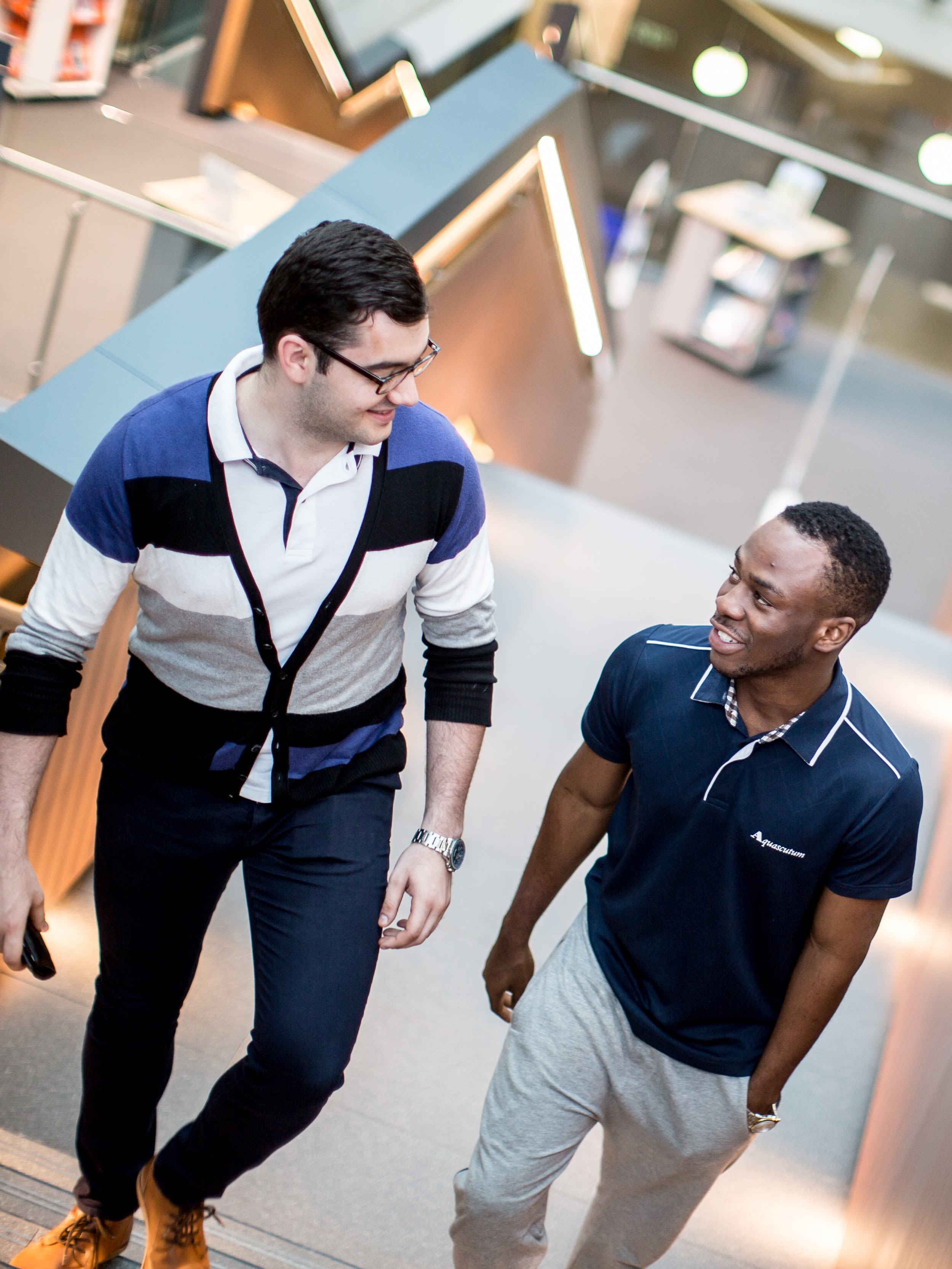 Students walking up the stairs in the forum building