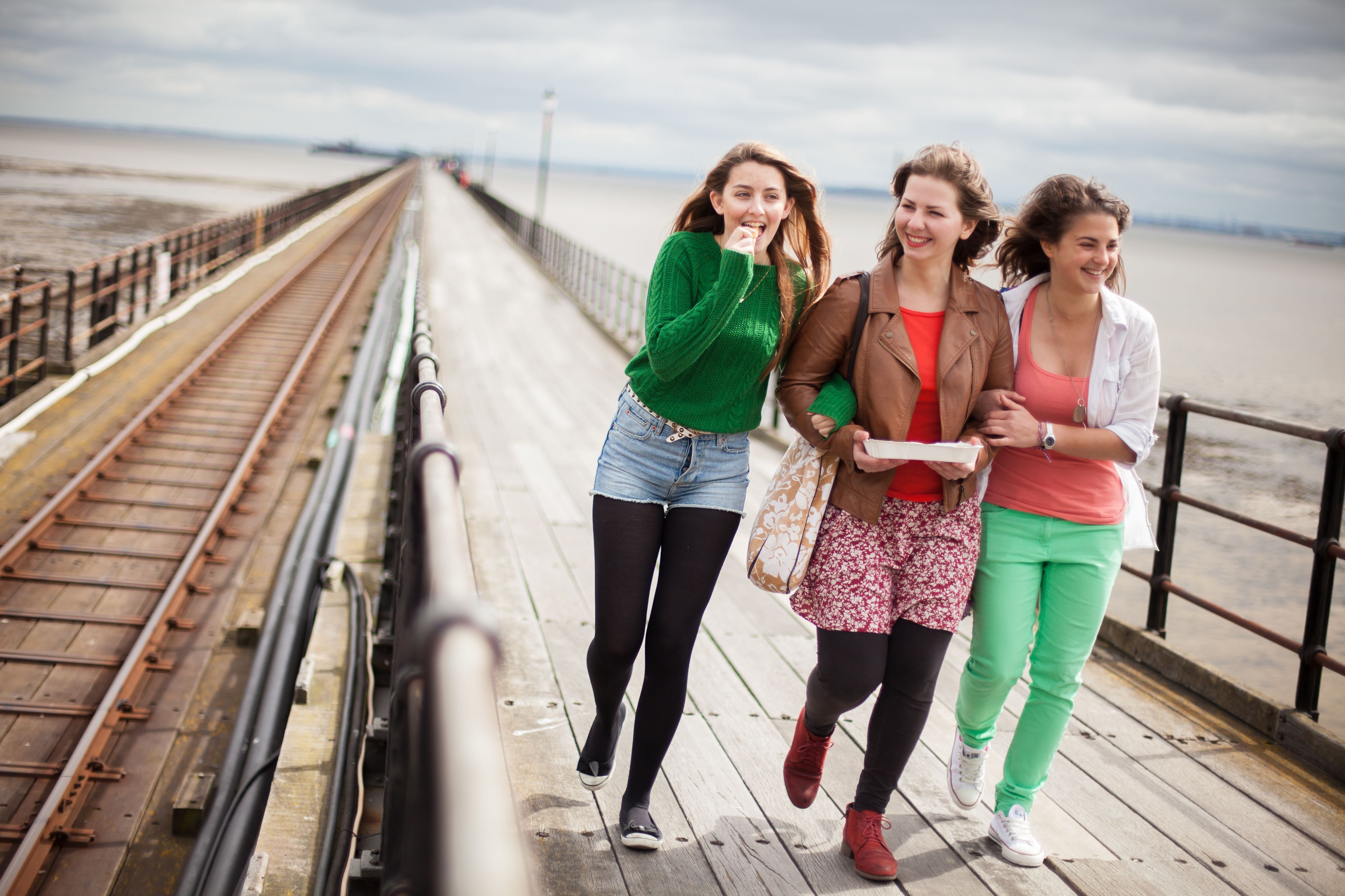 Students walking along the pier
